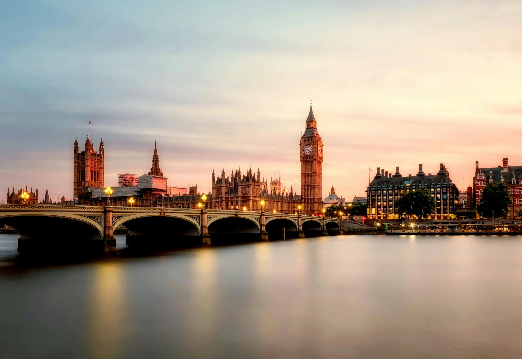 water at the front, then bridge, and then Big Ben looking golden.